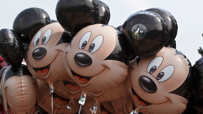 FILE - Mickey Mouse balloons appear at Disneyland Paris, May 12, 2015, in Chessy, France, east of Paris.{ } (AP Photo/Michel Euler, File)